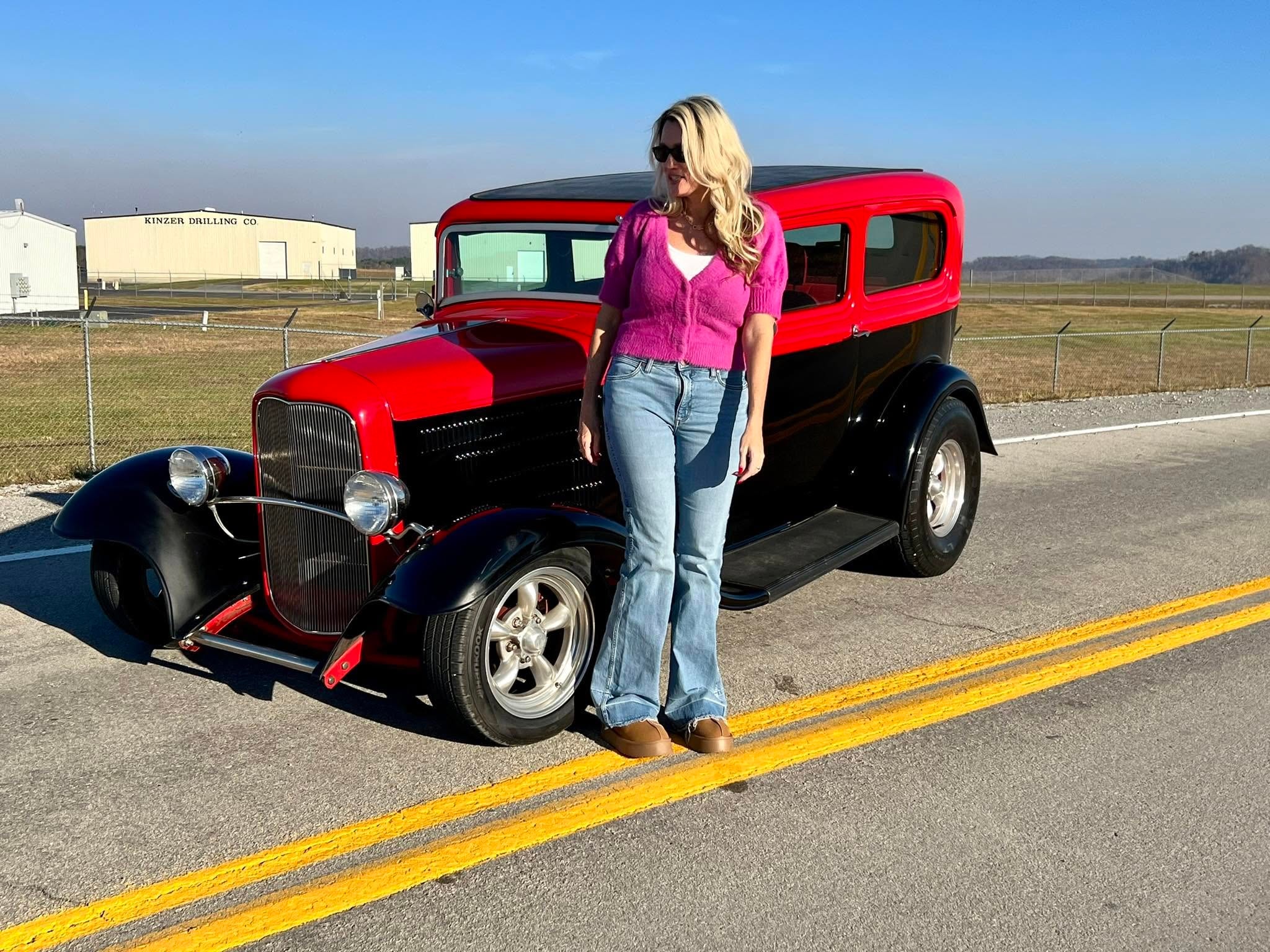 Cyndi Owens with a classic red and black hot rod