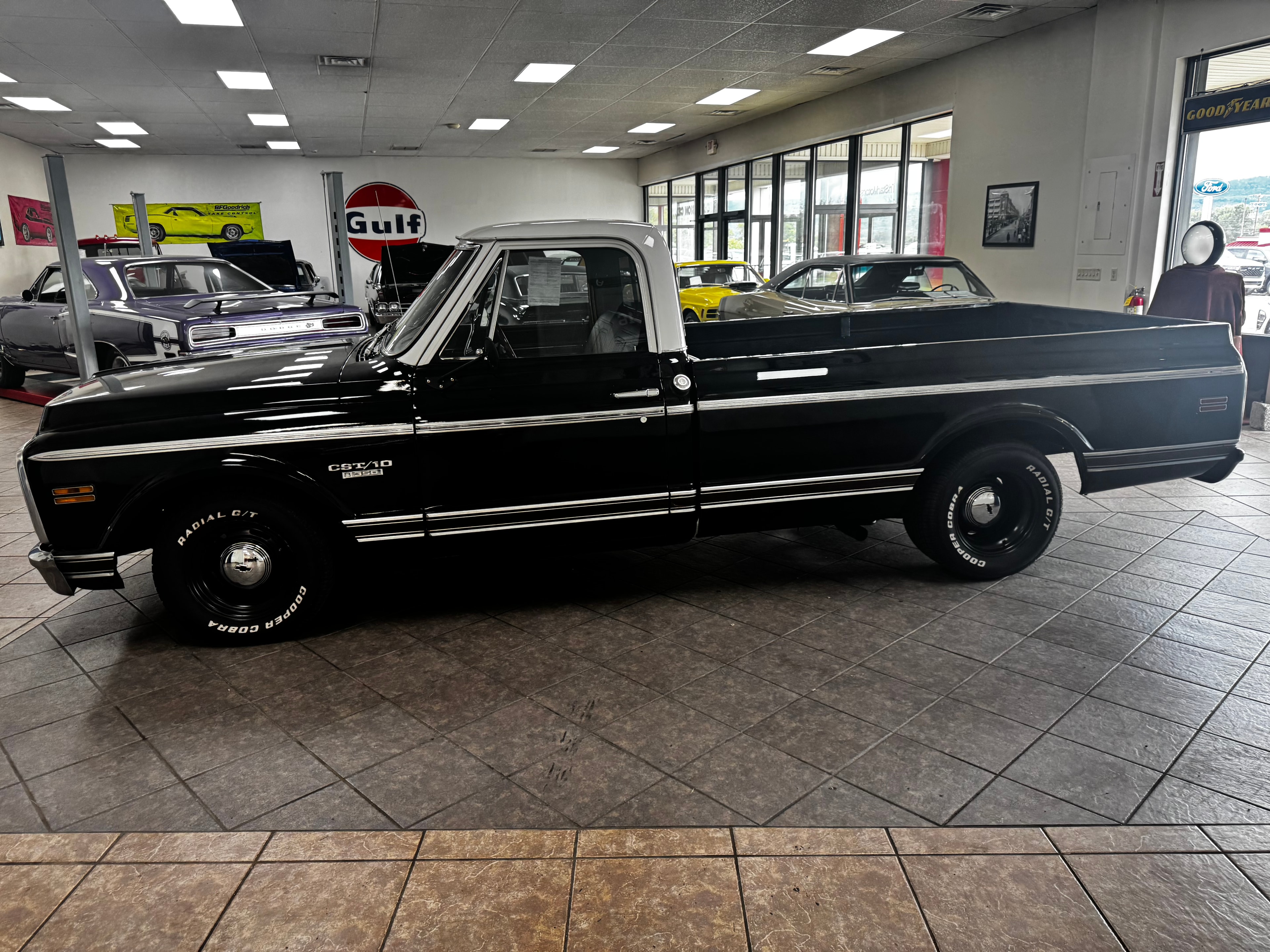 Black Chevrolet C10 long bed on showroom floor